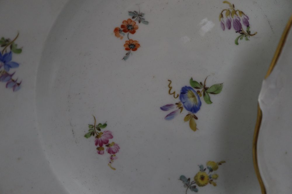 Three Meissen floral and gilt decorated plates, diameter 24cm